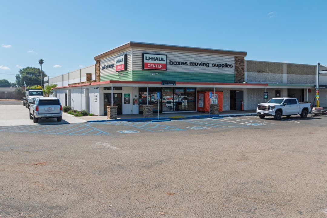 Charming single-family home with a front porch and lush landscaping in a sunny neighborhood.