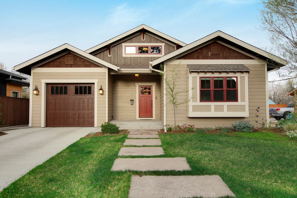 charming modern house with garage and front walkway surrounded by greenery